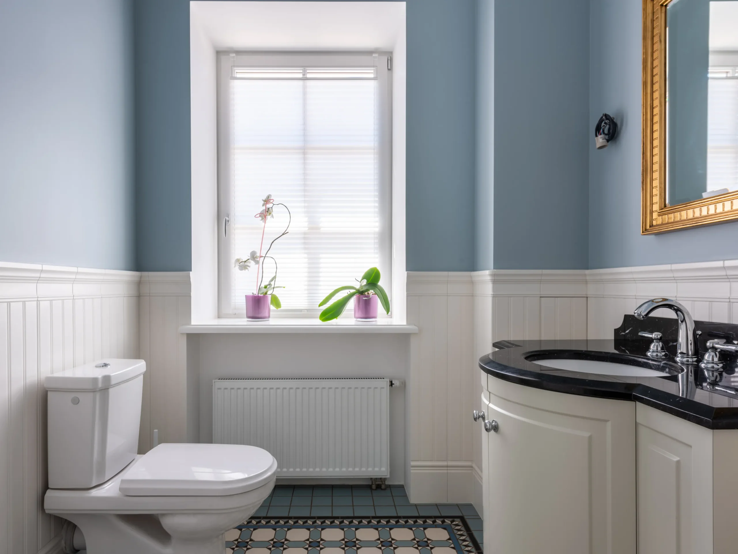 bathroom with blue walls and new decorations for 2025 home renovation trends 