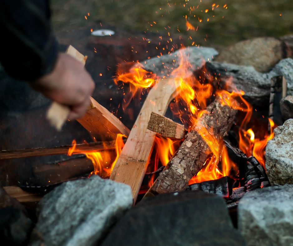 Stoking a fire with wood in it