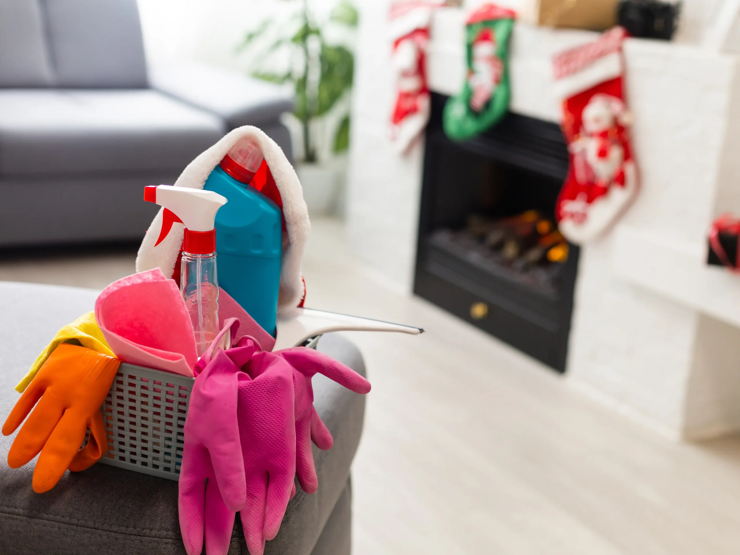 cleaning supplies next to Christmas fireplace as ideas for gifts for new homeowners