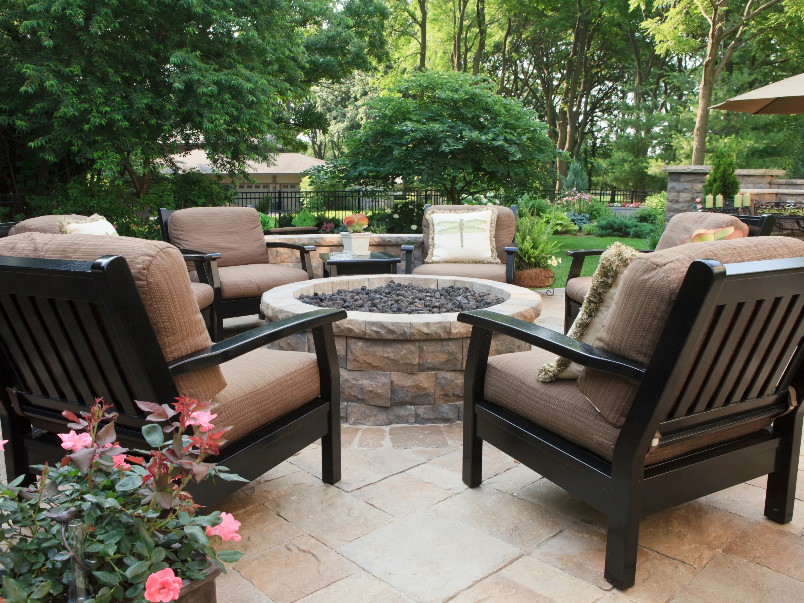 backyard fire pit setup with chairs and stone ring
