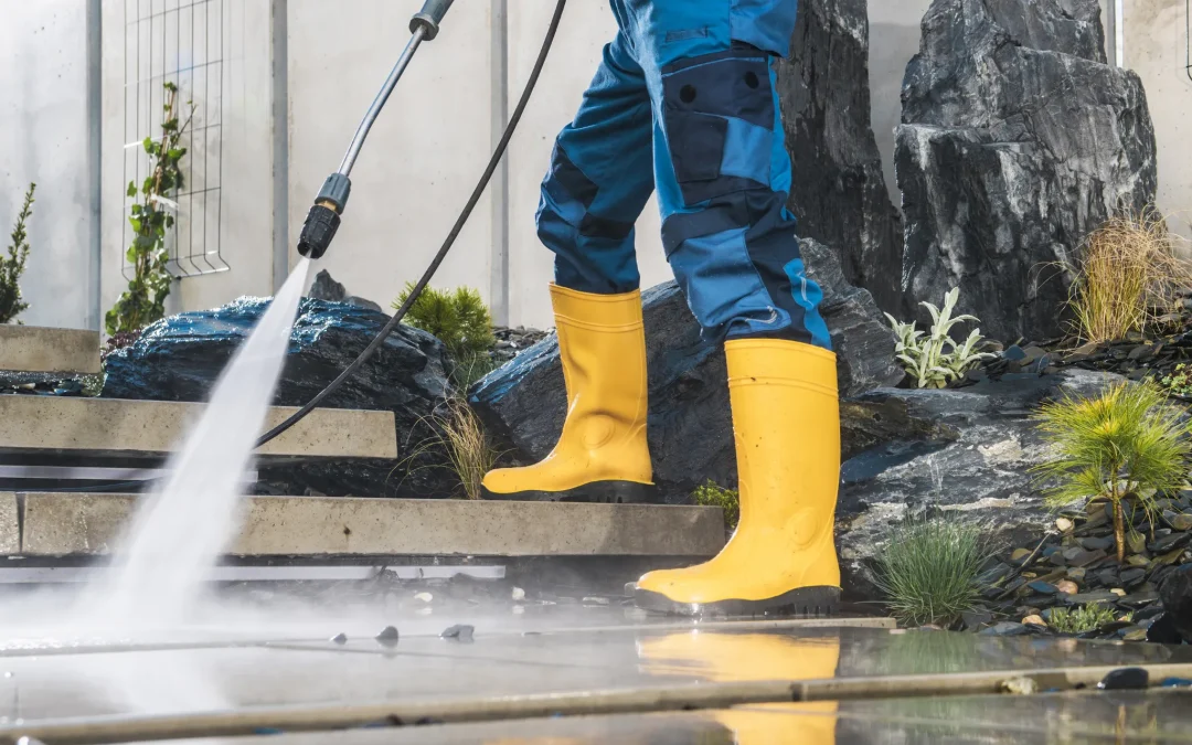 how to pressure wash like a pro blog cover - person pressure washing a walkway